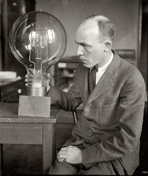 March 12, 1925. &quot;C.W. Mitman of Smithsonian Institution with giant and midget bulbs.&quot; National Photo Company Collection glass negative.